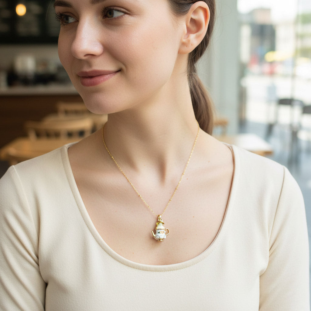 Woman wearing a necklace with a teapot pendant in an indoor setting
