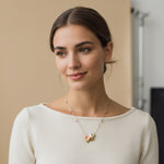 Woman wearing a necklace with a neutral background