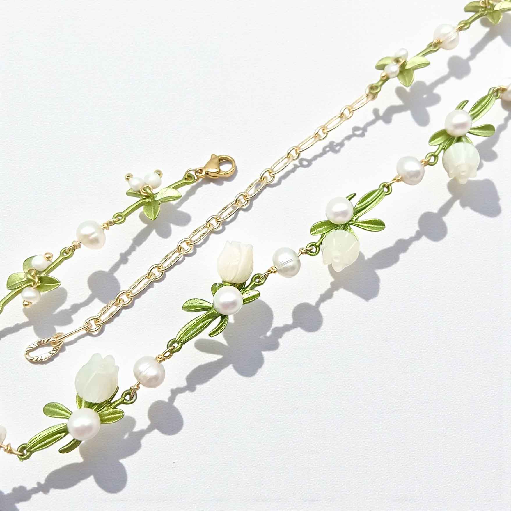 Necklace with floral and pearl design on a light background