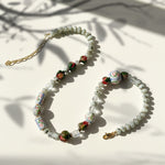 Beaded necklace with floral beads on a light background