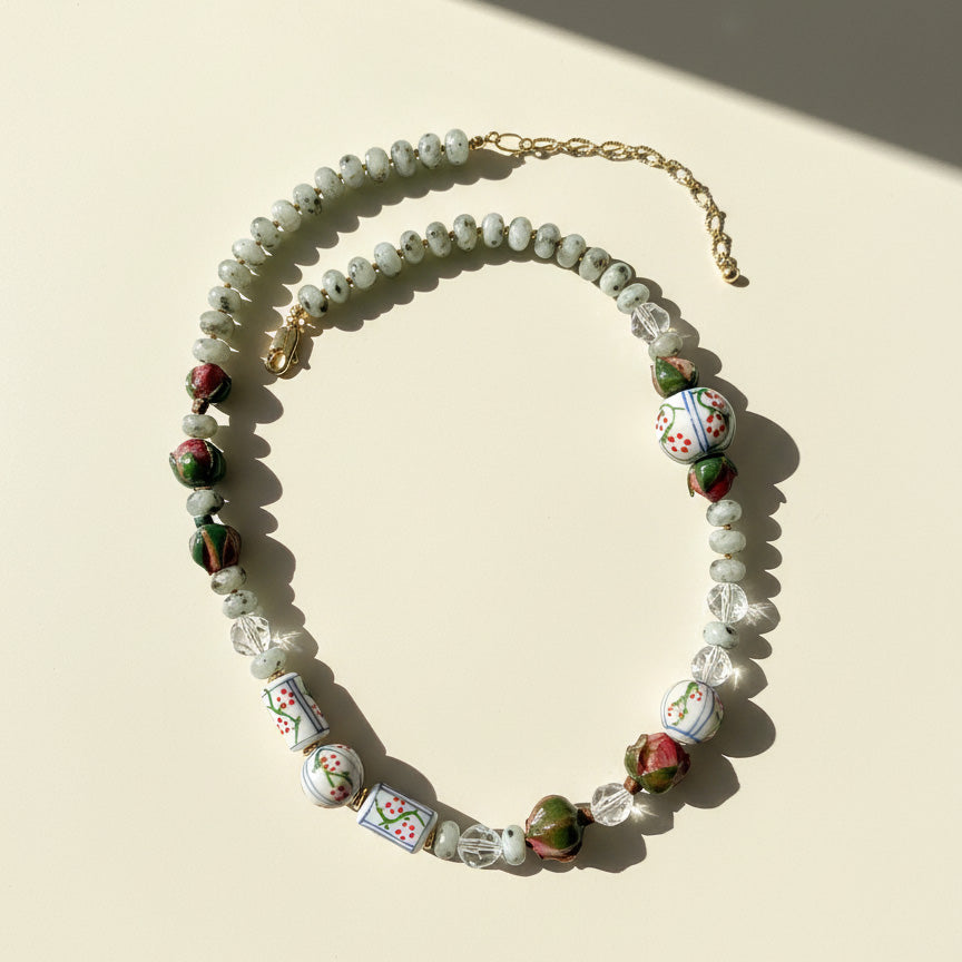 Necklace with floral beads on a beige background