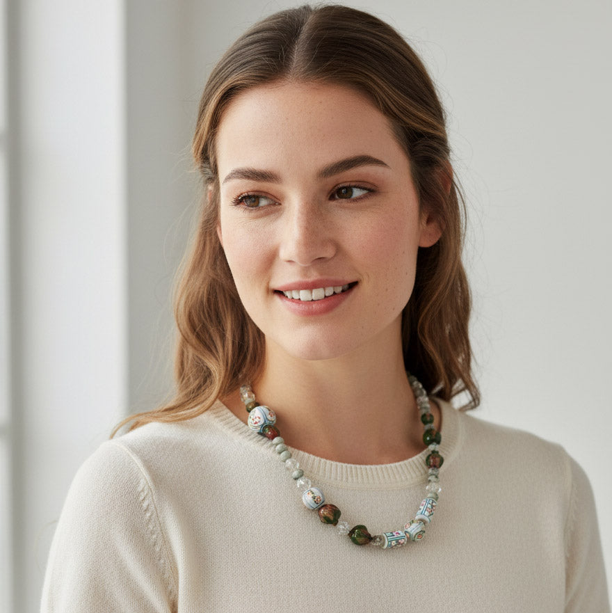 Woman wearing a necklace with a plain background