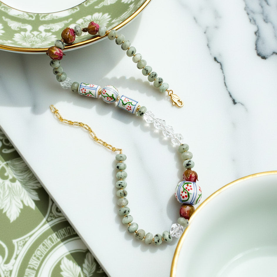 Necklace with decorative beads on a marble surface