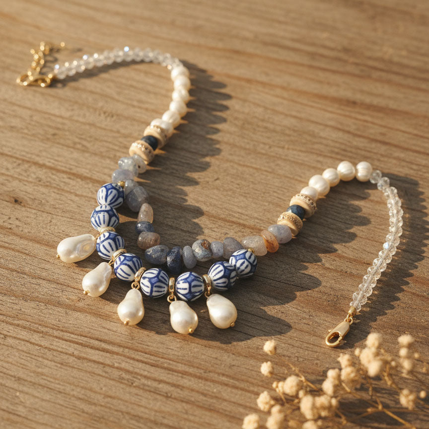 Necklace with pearls and blue ceramic beads on a wooden surface