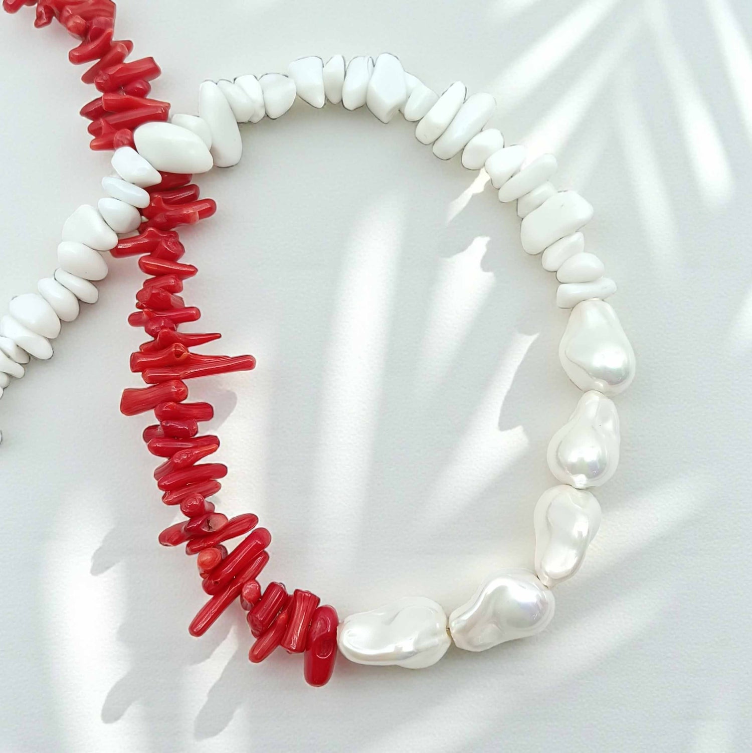 Necklace with red and white beads on a white background