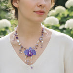 Orchid floral necklace worn on model in natural light