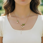 Close-up of hand-painted lily of the valley floral pendant
