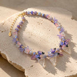Close-Up of Butterfly Bloom Garden Necklace with Handcrafted Floral and Butterfly Details on a stone surface