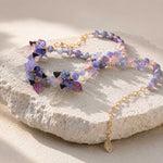 Butterfly Bloom Garden Necklace Displayed on Natural Stone Surface with Floral Details