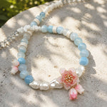 Botanical Lotus Necklace with Amazonite Stones on a sandy surface