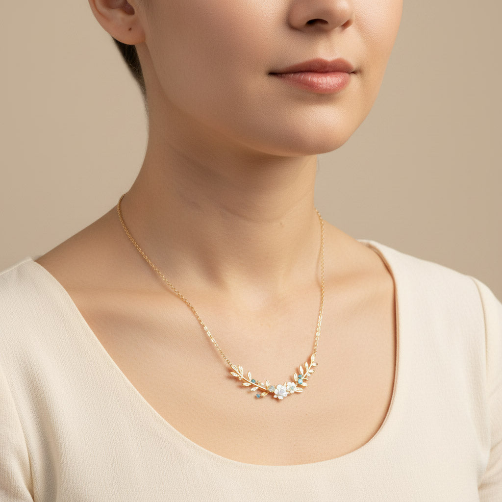 Necklace with floral design worn by a person against a neutral background