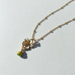 Necklace with a floral pendant on a light gray background