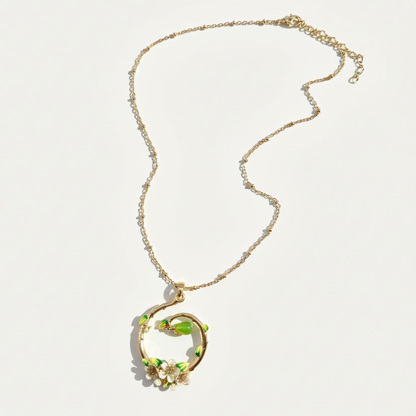 Gold plated necklace with circular pear blossom enamel pendant on chain