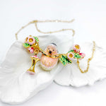 Necklace with a pink hedgehog charm on a white shell background