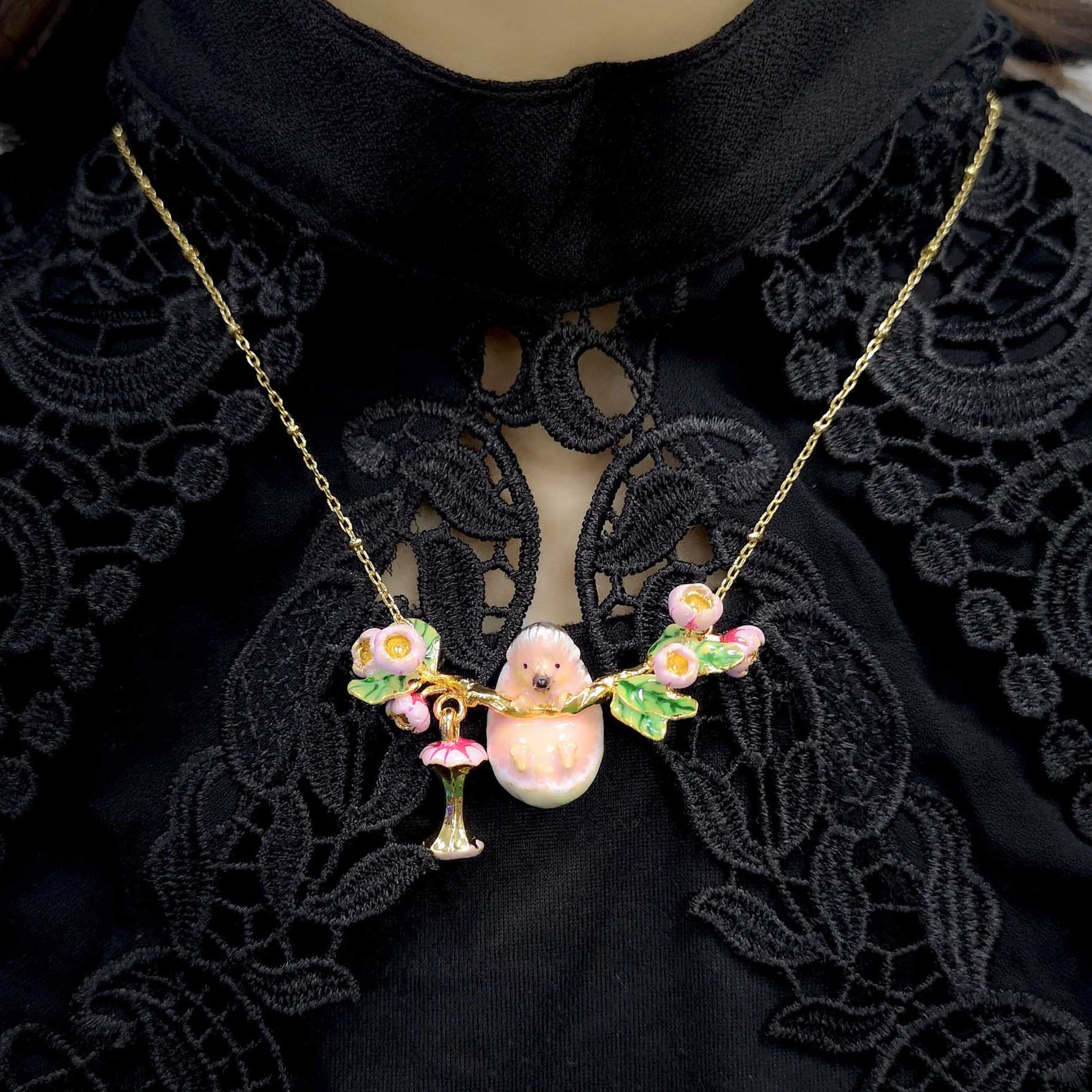 Necklace with a hedgehog pendant on a black lace background