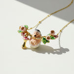 Necklace with a hedgehog and floral pendant on a light background