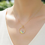 Gold necklace with a bird pendant on a mannequin