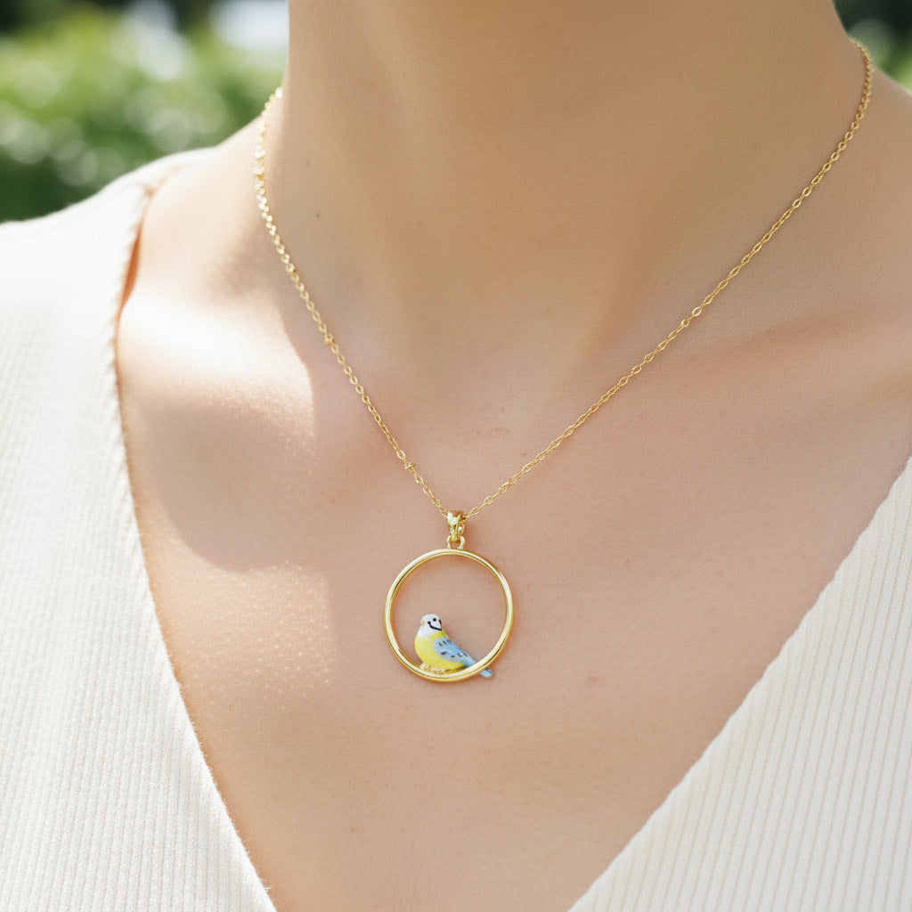 Gold necklace with a bird pendant on a mannequin