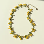 Handcrafted berry garden necklace with yellow semi-precious stone beads and green enamel leaves on gold-plated chain