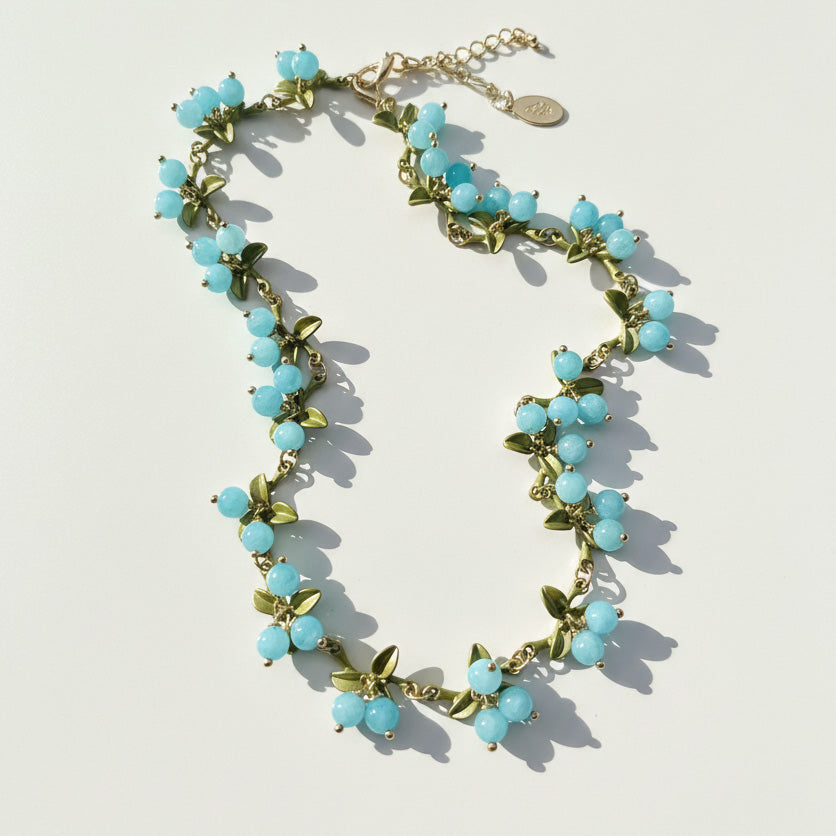 Aqua blue berry garden necklace with semi-precious stone beads and enamel leaf details on gold-plated brass
