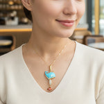 Woman wearing a necklace with a blue whale pendant in a casual setting