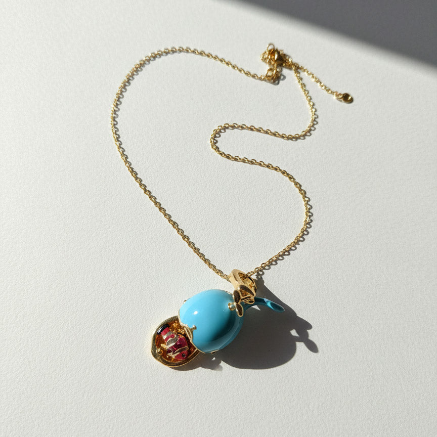 Necklace with a blue pendant on a light gray background