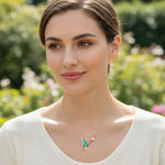 Woman wearing a necklace with a colorful pendant in a garden setting