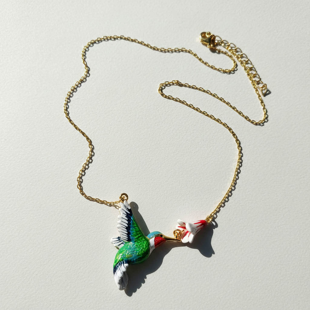 Necklace with a colorful parrot pendant on a light gray background