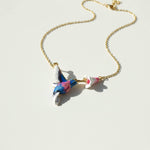 Necklace with a colorful bird pendant on a light background