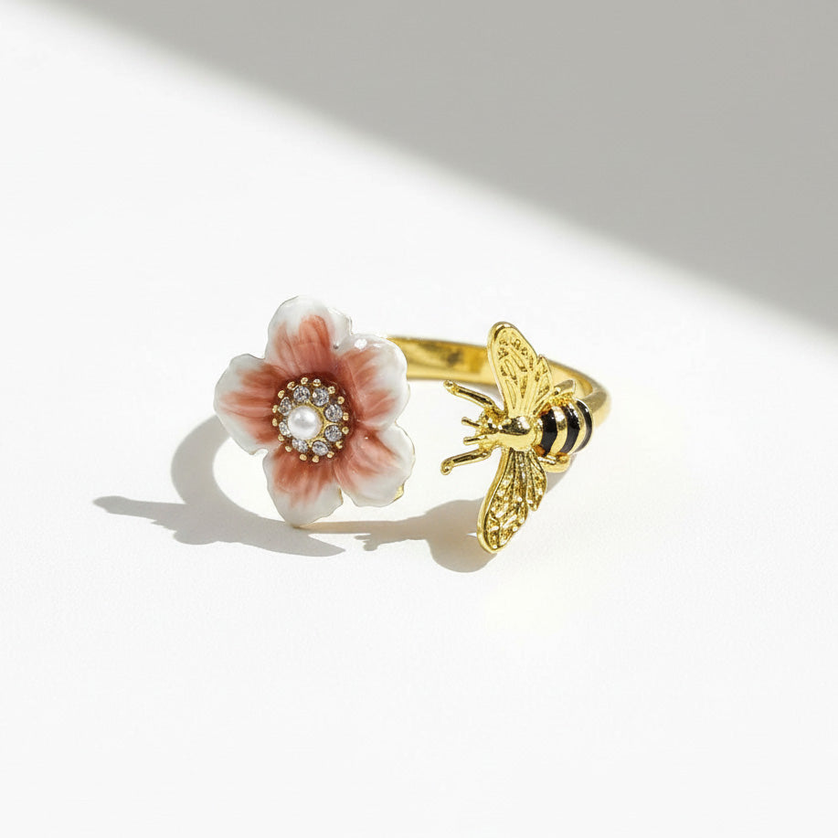 Gold ring with a floral design on a white background