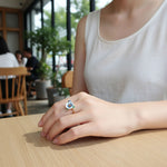 Person wearing a floral ring in a casual setting