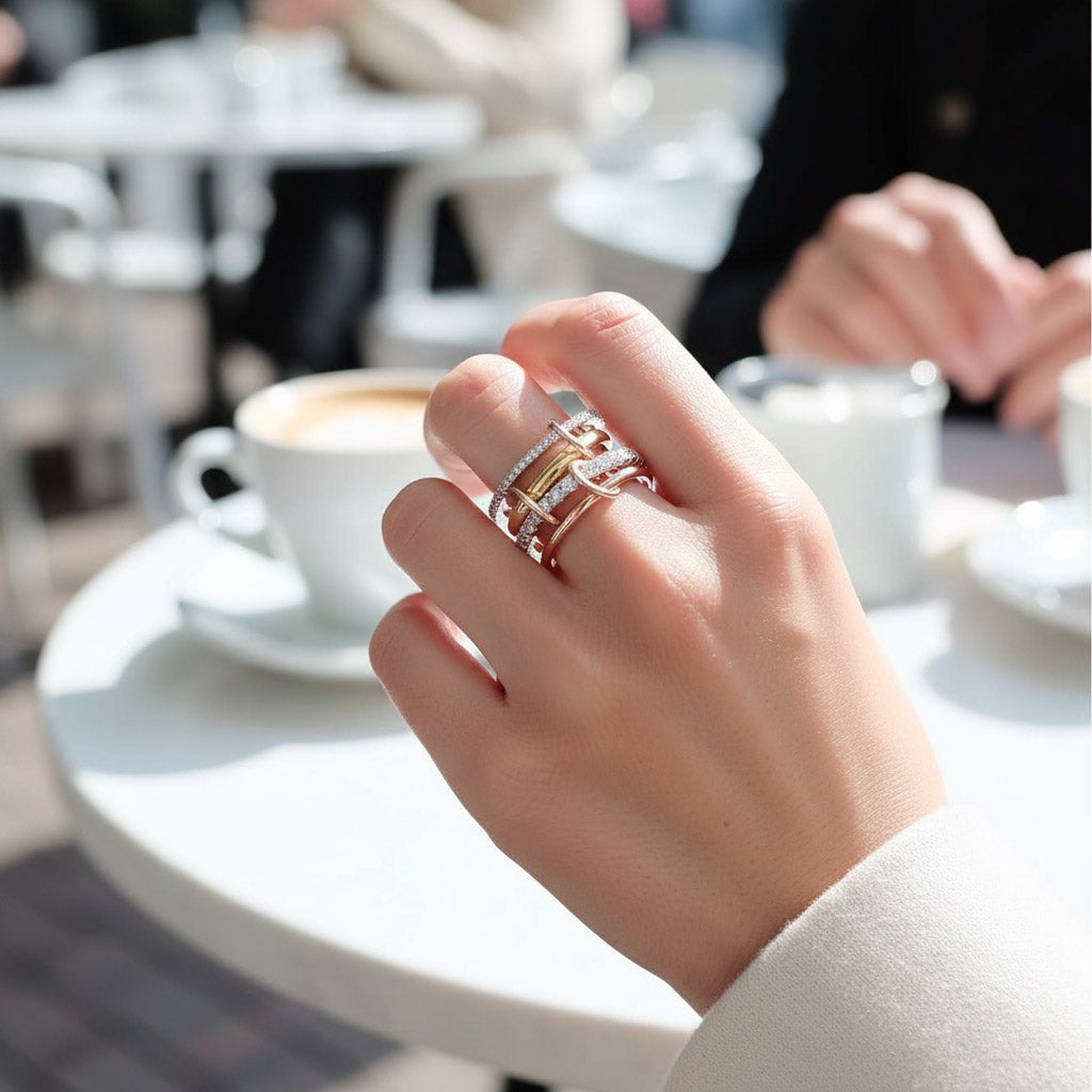 Hand with multiple rings on a blurred cafe background