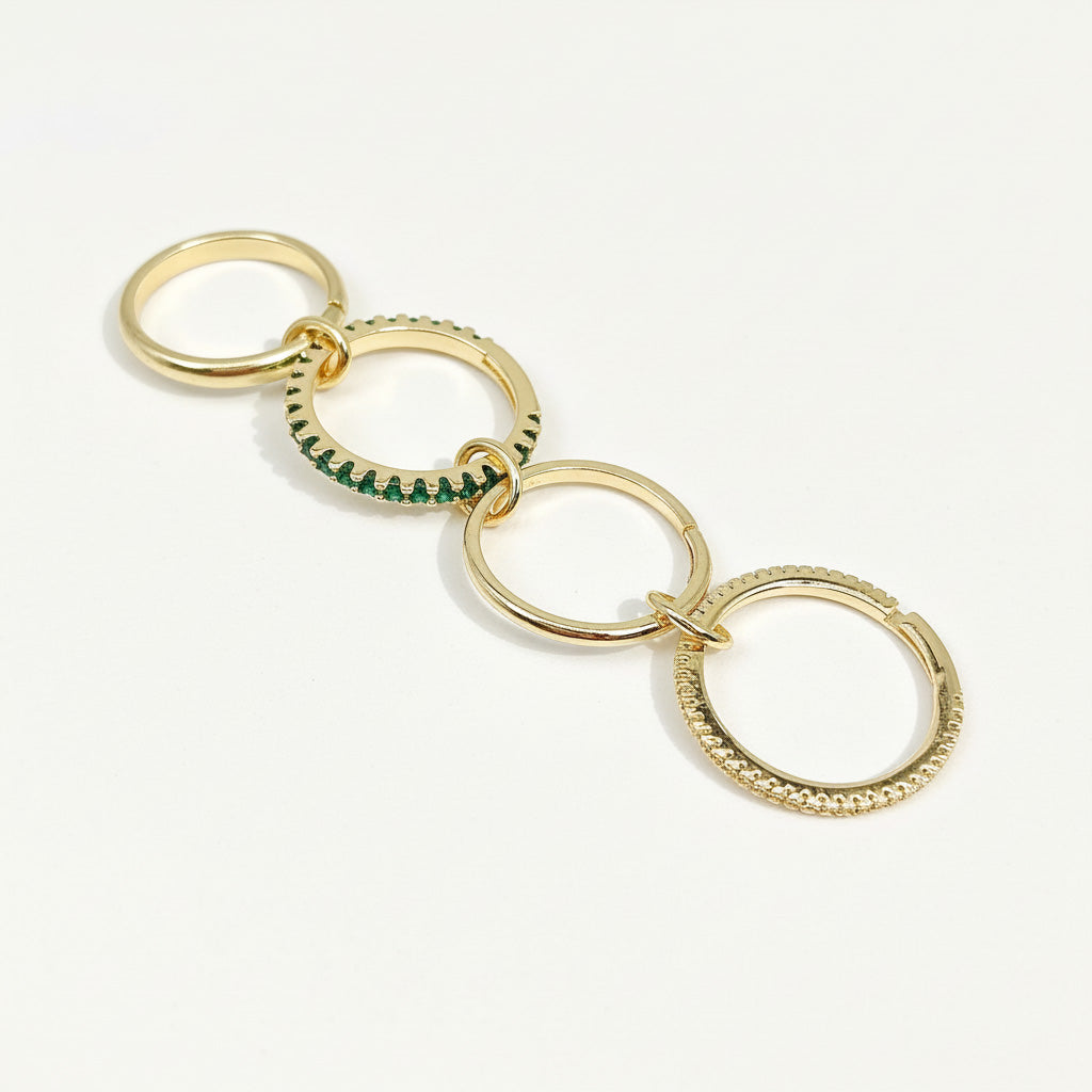 Gold keychain with interlocking rings on a white background