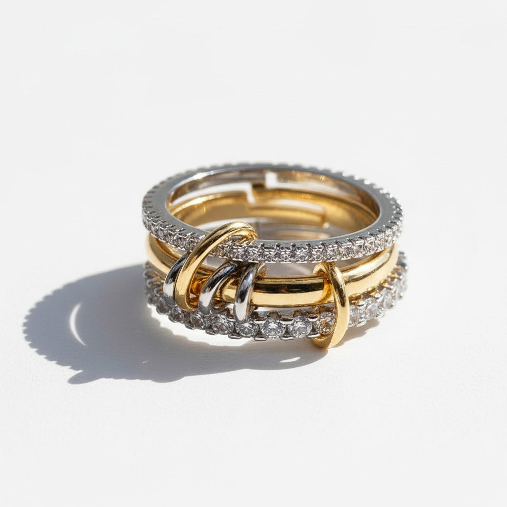 Three gold rings with diamond accents on a light background