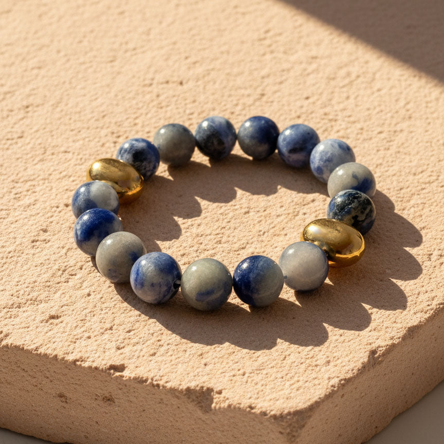 10mm Blue Aventurine bracelet with gold PVD stainless beads on natural stone display