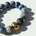 Close-up of Blue Aventurine gemstone beads with polished gold stainless steel bead detail