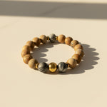 Natural Picture Jasper gemstone bracelet with Zebra Jasper accent beads on a beige background