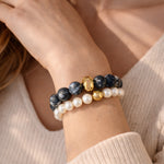 Picasso Jasper gemstone bracelet paired with freshwater pearl bracelet worn on wrist