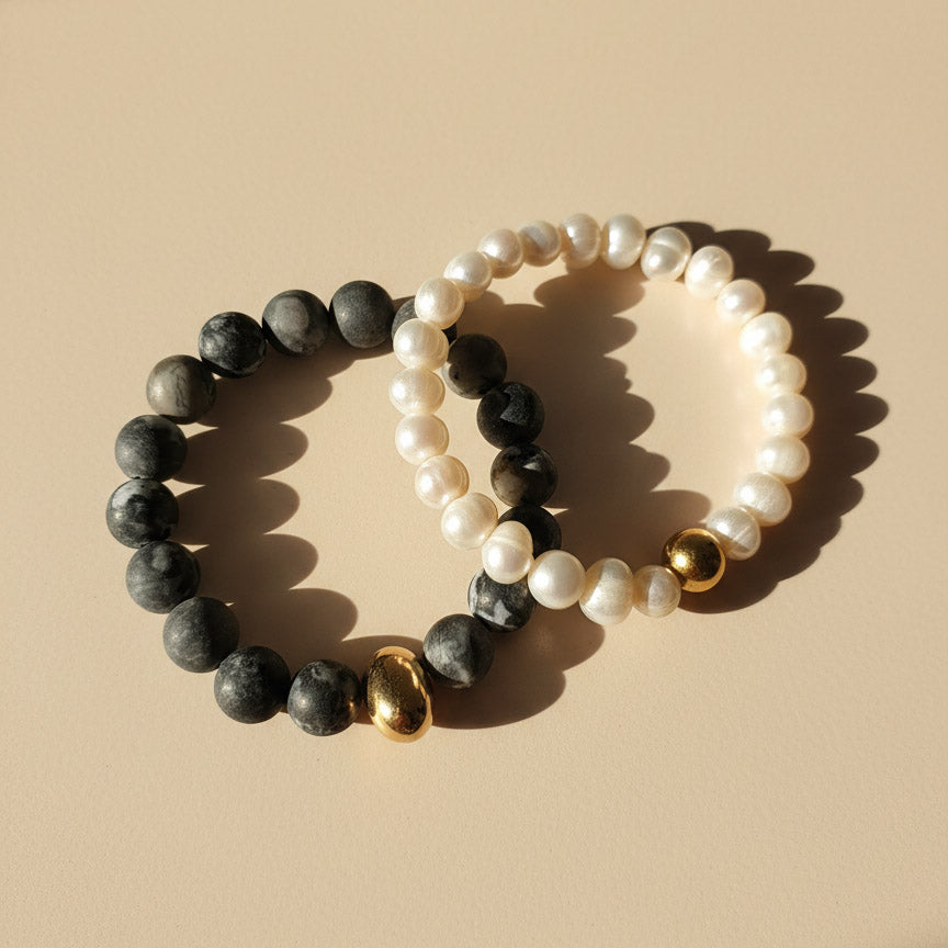 Natural Picasso Jasper and freshwater pearl bracelets in warm sunlight