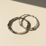 Black rutilated quartz and zebra jasper bracelet layered with pearl bracelet