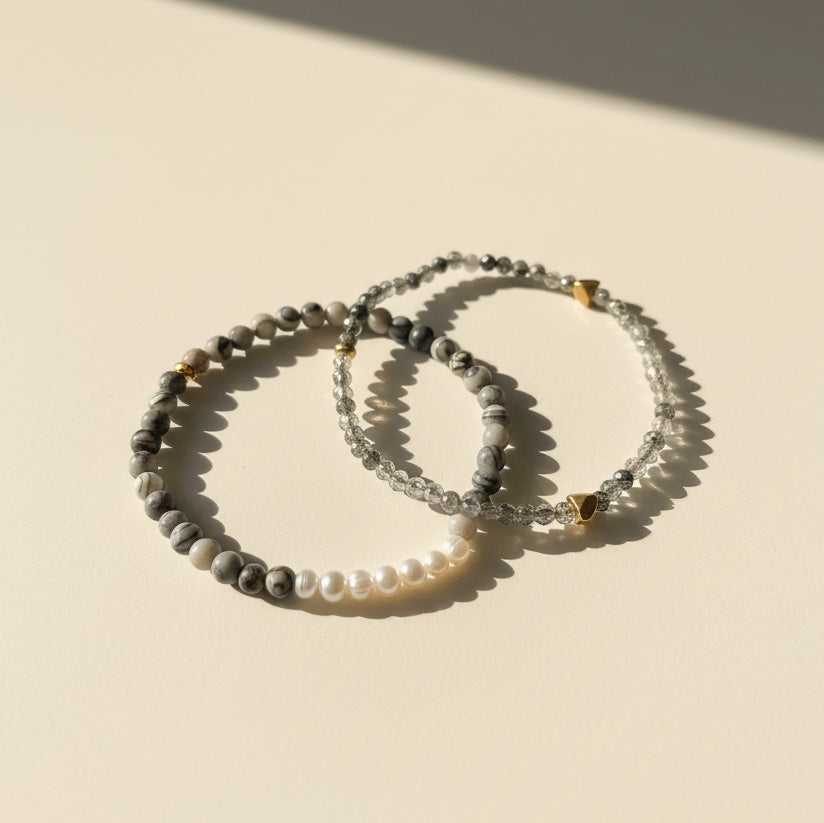 Black rutilated quartz and zebra jasper bracelet layered with pearl bracelet