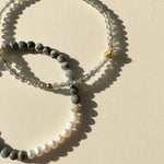 Close-up of zebra jasper gemstone beads with freshwater pearl and gold stainless steel accent