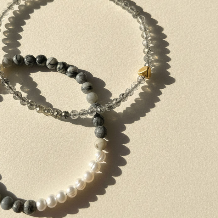 Close-up of zebra jasper gemstone beads with freshwater pearl and gold stainless steel accent