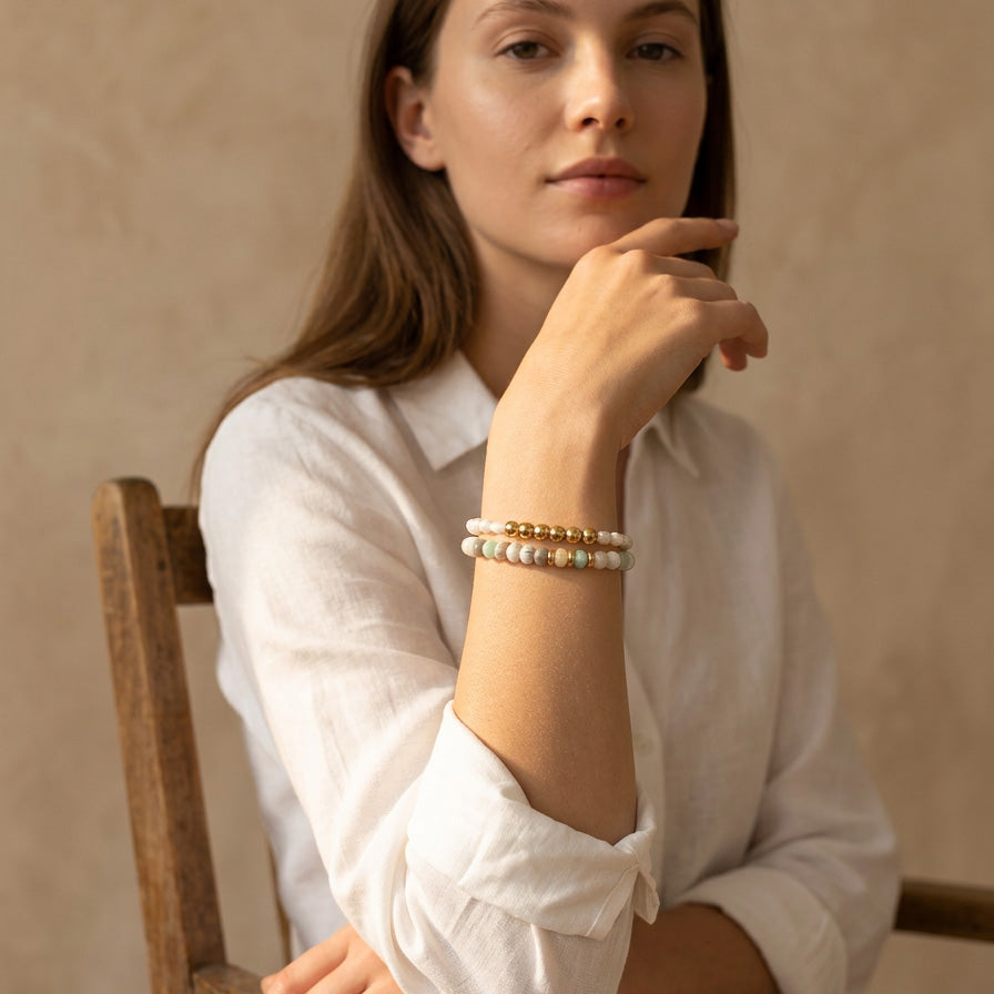 Amazonite and white turquoise bracelet set with freshwater pearl worn on wrist in natural sunlight