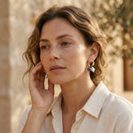 Model wearing sodalite pearl drop earrings in warm sunlight
