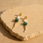 Woman wearing ruby zoisite gemstone drop earrings with pearl accents