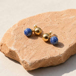 Sodalite sculptural ball earrings on terracotta stone