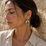 Woman wearing Map Jasper gold hoop earrings
