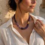 Model wearing the A2K London amethyst sculptural necklace with natural amethyst gemstone beads and an organic gold PVD stainless steel accent.